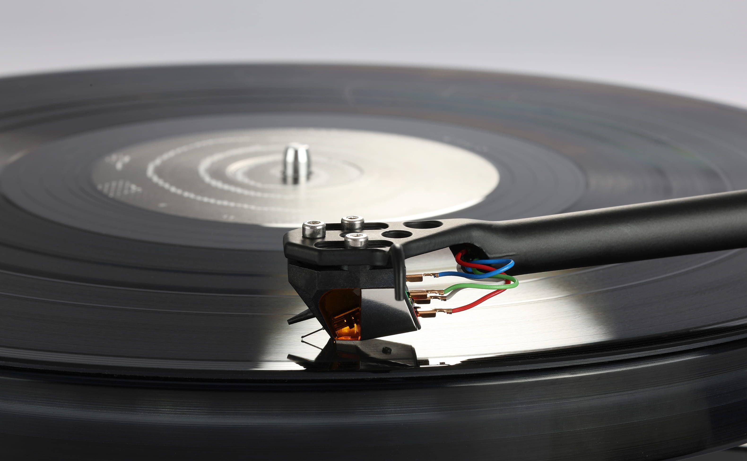Rega ND9 Moving Magnet Phono Cartridge capturing sound from a vinyl record on a turntable.