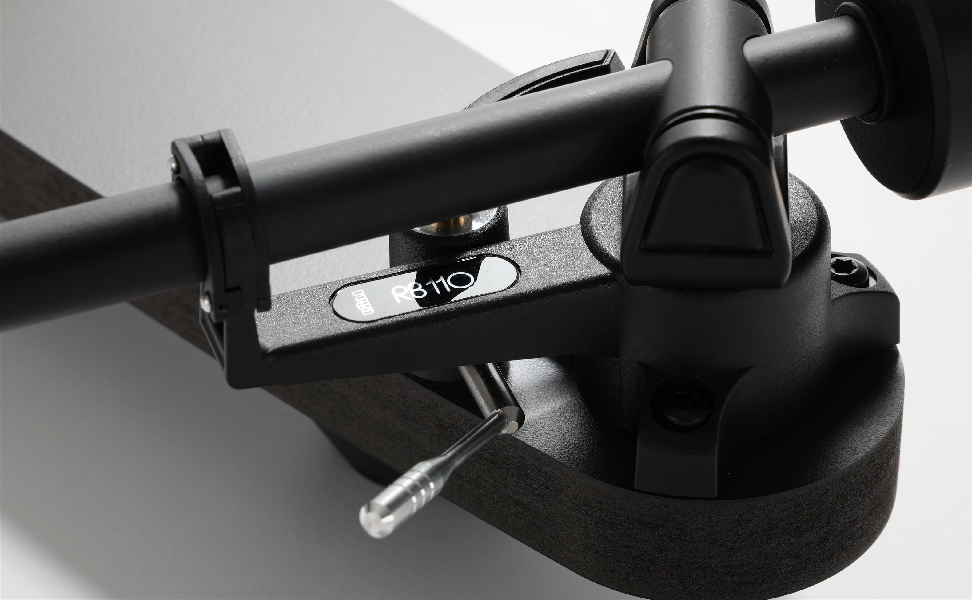 Rega Replay Plug and Play Turntable with Rega Carbon Cartridge RB110 tonearm close-up detail image.