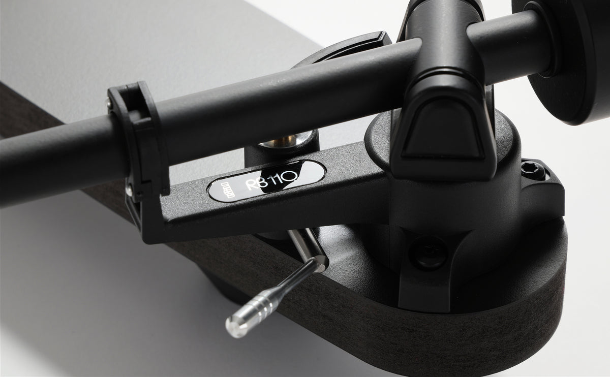 Rega Replay Plug and Play Turntable with Rega Carbon Cartridge RB110 tonearm close-up detail image.