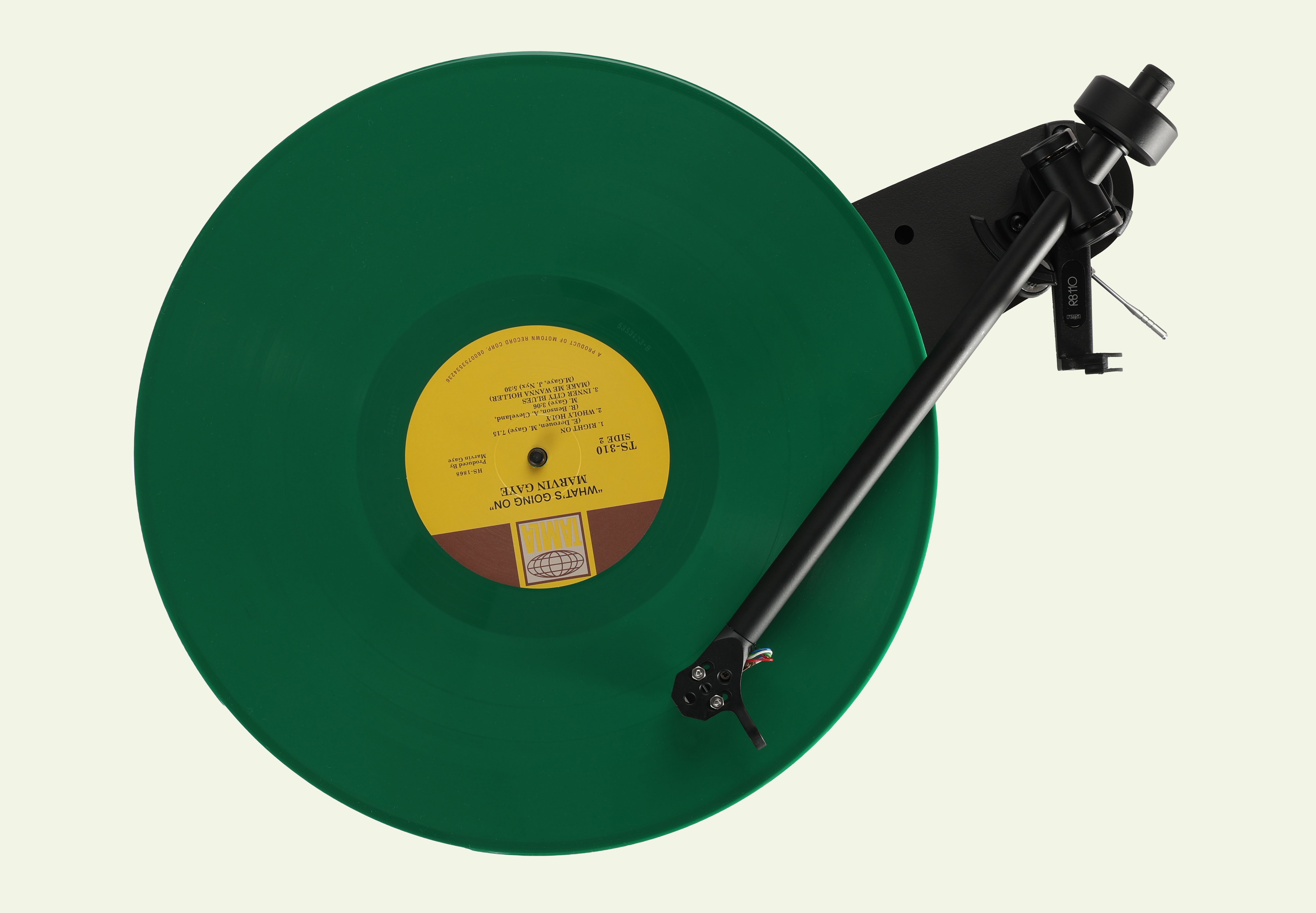 Rega Replay Plug and Play Turntable with Rega Carbon Cartridge showcasing a green vinyl record on the turntable.