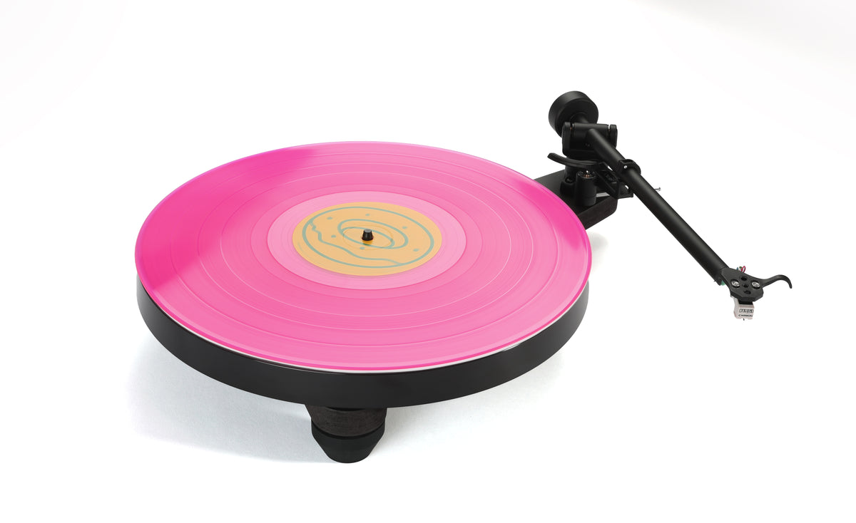 Rega Replay Plug and Play Turntable with Rega Carbon Cartridge displaying a pink vinyl record.